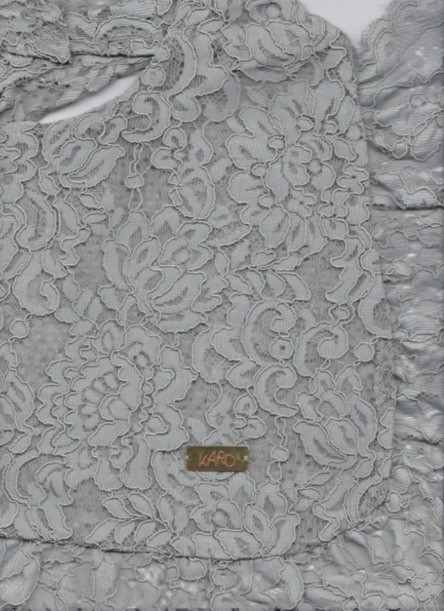 grayish green lace fabric with a brand label on a matching gray background