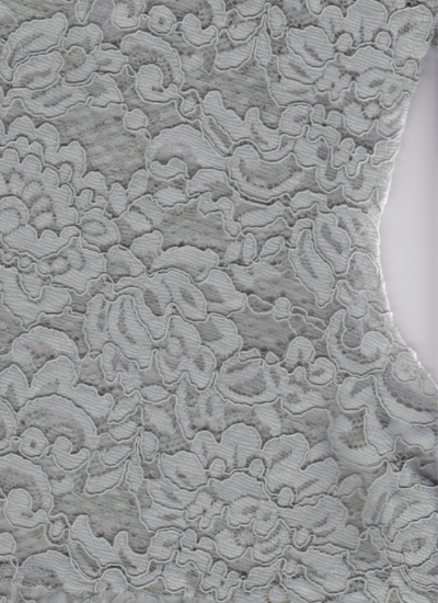 Close-up of grayish green textured fabric with floral patterns