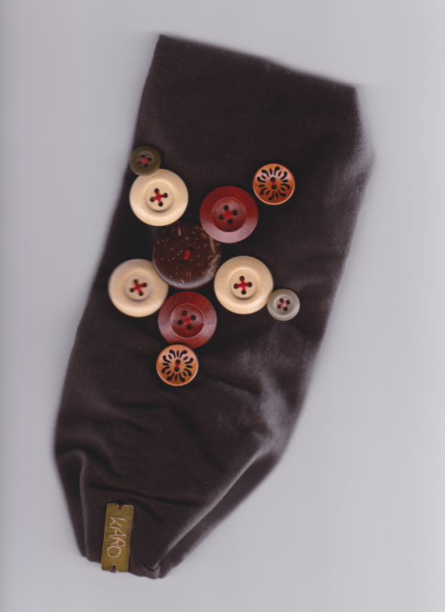 Brown headband with buttons on a white background